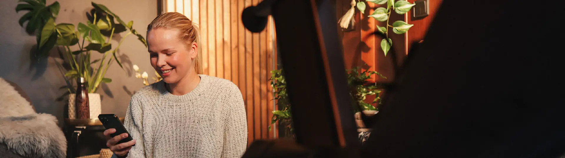 En kvinna tittar i sin telefon.